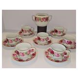 Seven teacups with saucers and sugar bowl.