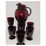 Mid Century Anchor Hocking Royal Ruby Red Ball Pitcher (rollie pollie) featuring a rounded, translucent ruby-red glass body and a dark glass handle with an ice lip and 6 glasses (5 in tall). This set 