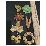 Grouping of brooches. Double Leaf Imitation Pearl and Rhinestone Brooch is  Benedikt NY. Very pretty selection.