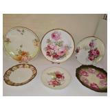Six porcelain plates with hand painted roses. 7-10 in. diameter.