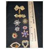 Grouping of brooches. Bottom right heart is trafari