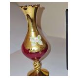 Ruby red amberina glass vase features an elegant twisted gold stem with hand-painted floral gilding. 6.75 in tall.