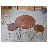 Vintage ice cream parlor table and chairs. Wood tops need refinished. Table is 23.75 in diameter 30 in tall. Chairs are 14.25 in diameter x 35 in tall. Seat height is 17.75 in.