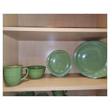 Green Mainstays stoneware. Includes four dinner plates, four salad plates, three cereal bowls, one soup mug, and four beverage mugs
