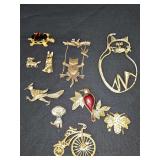 Grouping of brooches. Cats, dogs, turtle, roadrunner, birds, bicycle and more.
