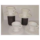 Four Indiana Glass Colony Harvest milk glass cups and saucers with grape and vine pattern.
