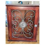 Small cabinet with metal scroll front door. 14.5 x 6.5 x 17.25 in tall.