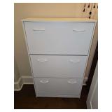 White laminate three drawer shoe storage cabinet. 29.5 x 11.75 x 47.5 in tall.