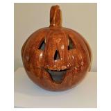Terracotta pumpkin with cut out for a candle or lighting. 10 in diameter x 12 in tall.