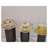 Three cup and saucer sets.