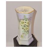 Hand-painted porcelain hat pin holder with yellow and purple florals on a hexagonal base. Andrea by Sadek. 4 5/8 inches tall.
