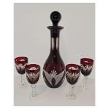 Beautiful Bohemian cut-to-clear deep ruby red crystal decanter and matching stemware set featuring hand-cut clear glass panels and starburst motifs. Decanter is 13.5 including stopper stems are  5 3/8