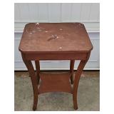 Vintage/antique wooden two-tiered end table featuring a square top, curved saber legs, and a lower display shelf. 15 x 18 x 27 in tall.