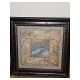 Framed print featuring a bluebird within an ornate scrollwork and floral motif.   13.5 x 13.5 in tall.