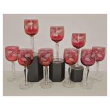 9 cranberry glass wine goblets featuring a flash-stain finish and an etched frosted leaf pattern along the bowl with a clear glass stem. 5 7/8 in tall.