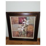 Framed print of lilies by artist S. Vassileva. 24.5 x 24.5 in tall.