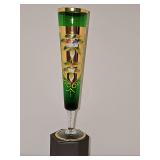 Beautiful Bohemian/Venetian emerald green glass footed vase featuring intricate gold-gilding and hand-painted floral accents. 10 in tall.
