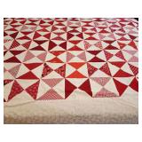 Machine stitched quilt top ready for backing, batting, and quilting. Hourglass block, scrappy red-and-white traditional style,  various prints, polka dots, bandanas, florals, chevrons, and ginghams, k