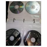 Binder of mixed genre cds. Will show several. There are approximately 52 CDs in the binder.