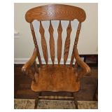 Solid oak rocking chair. 25 x 18.5 x 42.5 in tall. Seat height 16.75 in.