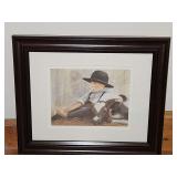 MID-MORNING (also known as "My Calf") by the late artist Nancy Noel (N.A. Noël), featuring an Amish boy resting next to a calf. 11.75x9.75 in tall.