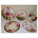 Five porcelain plates with hand painted roses. 8.25-9.5 in. diameter.