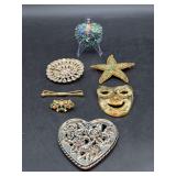 Grouping of vintage brooches and heart-shaped decorative mirror - peacock in back is combo brooch & pendant