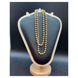 Long strand of brushed satin finish pearl-like necklace - doubled for pictures