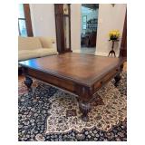 Haverty’s mahogany coffee table in the British Colonial style - square shape and includes a drawer on each side, legs are turned and fluted