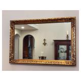 Vintage ornate gold-gilt rectangular wall mirror with a carved frame in a Baroque or Hollywood Regency style - 36-1/4 x 24-1/4