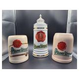 Grouping of (2) Pilsner Urquell tankards and (1) stein (top has been repaired)