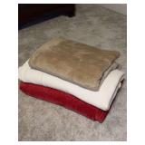 Grouping of (2) king size and (1) lap size blankets