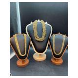 (3) elegant necklaces that can be dressed up or down - left is a heavier gold-tone link, center is a brushed satin finish multi-strand and right is a gold-tone flat link