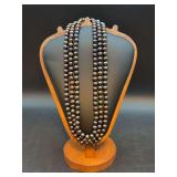 Research indicates these to be a triple strand of Cultured Freshwater Peacock Pearl Necklace with 14K yellow gold clasp