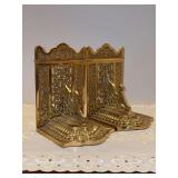 Vintage pair of heavy brass bookends featuring winged griffins - each measures 4-1/2w x 6-3/8 tall