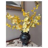 Bright yellow artificial dancing lady orchids arranged inside a dark, embossed decorative ceramic vase - vase stands 8-1/2” tall