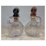 Grouping of (2) crystal cruets with marble-like stoppers - 6” tall