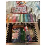 Box full of art supplies, markers, pencils, brushes, etc.