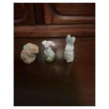 Group of three resin and porcelain miniature rabbits