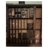 Assortment of vintage printing letter press, printer blocks. Display not included.