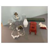 Assortment of vintage items, a 9 inch cast-iron ￼rabbit, an orange front porch mailbox 15 inches and an 18 inch metal box with two oil lamp bases and globes