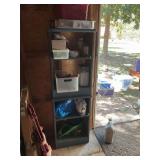 Blue shelving unit in storage shed with contents. 18” x 10” x 58”