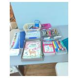 Assortment of pens, markers, coloring books, and etc/. art supplies