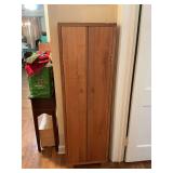 Two door wooden cabinet measuring 18 inches 9 1/2“ x 59“. Has seven shelves inside..