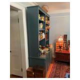 Painted blue shelving unit with four storage compartment underneath. This is one piece. Bring help to remove. 62“ x 20“ x 85.. contents not included