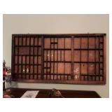 Antique wooden letter press tray used as a miniature display cabinet 32“ x 16 3/4”