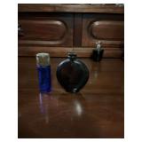 Two miniature cobalt blue bottles. The non lidded one is marked Worth.