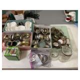 Large assortment of canning lids, and a couple of jars along with a box of four mini jars
