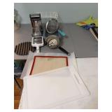 Assortment of miscellaneous kitchen items and a vintage masher
