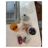 Assortment of necklace making supplies, including trays, containers, and beads